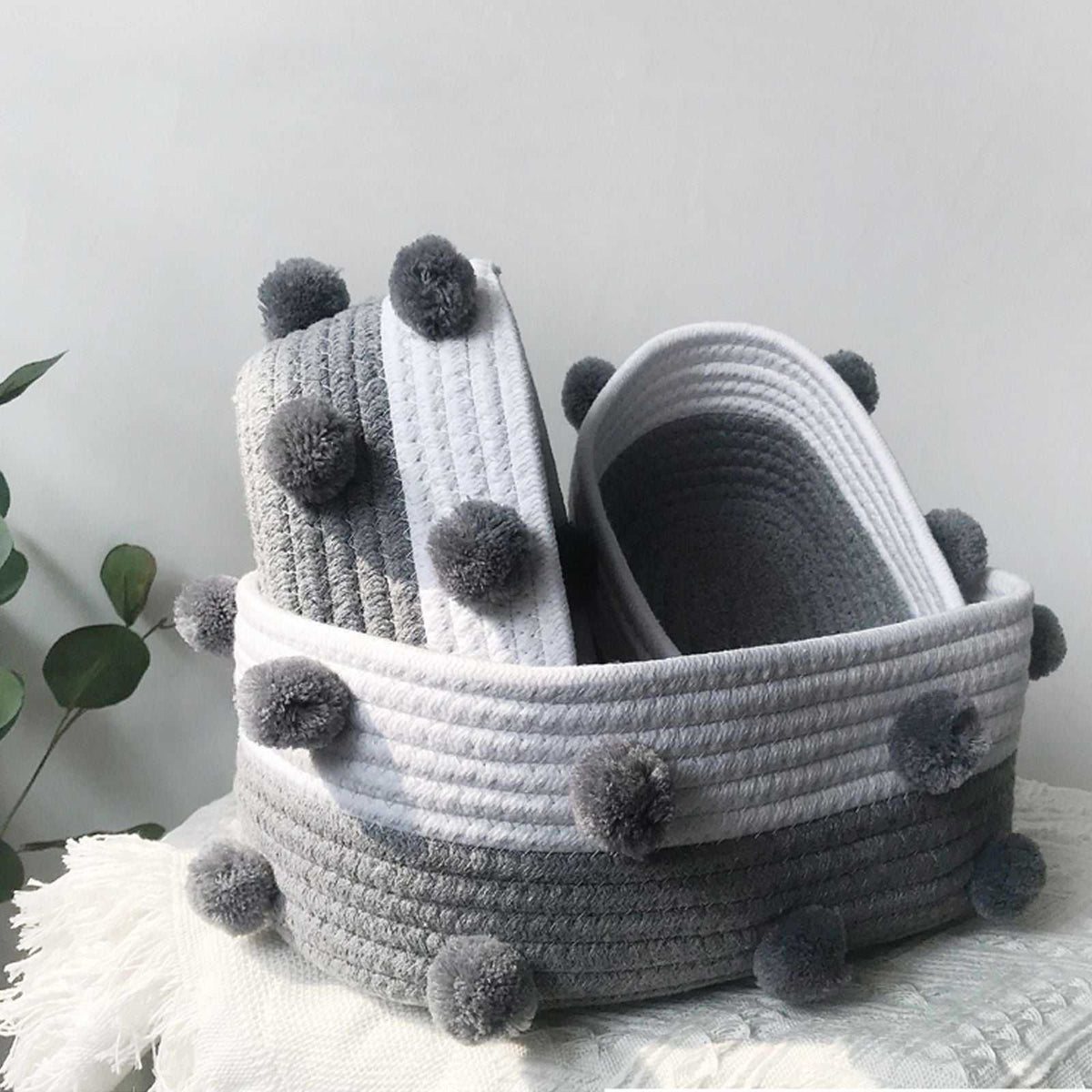 Cotton rope basket set in grey and white, with ribbed woven bands and soft grey pom-pom accents