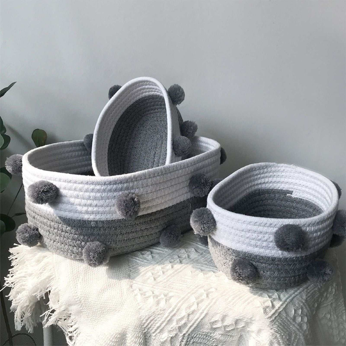 Cotton Rope Knitting storage baskets in white and grey woven cotton with fluffy grey pom-pom accents
