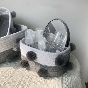 Cotton Rope Knitting storage basket in white and grey woven cotton rope, with fluffy grey pom-pom accents