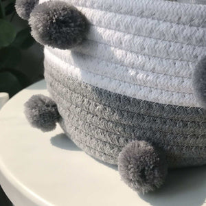 Cotton rope storage baskets in white and grey, tightly woven with fluffy dark grey pom-pom accents; Cotton Rope Knitting