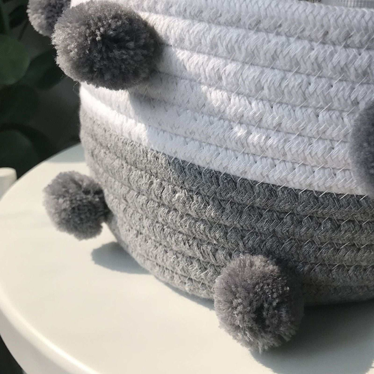 Cotton rope storage baskets in white and grey, tightly woven with fluffy dark grey pom-pom accents; Cotton Rope Knitting