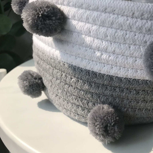 Cotton rope storage baskets in white and grey, tightly woven with fluffy dark grey pom-pom accents; Cotton Rope Knitting