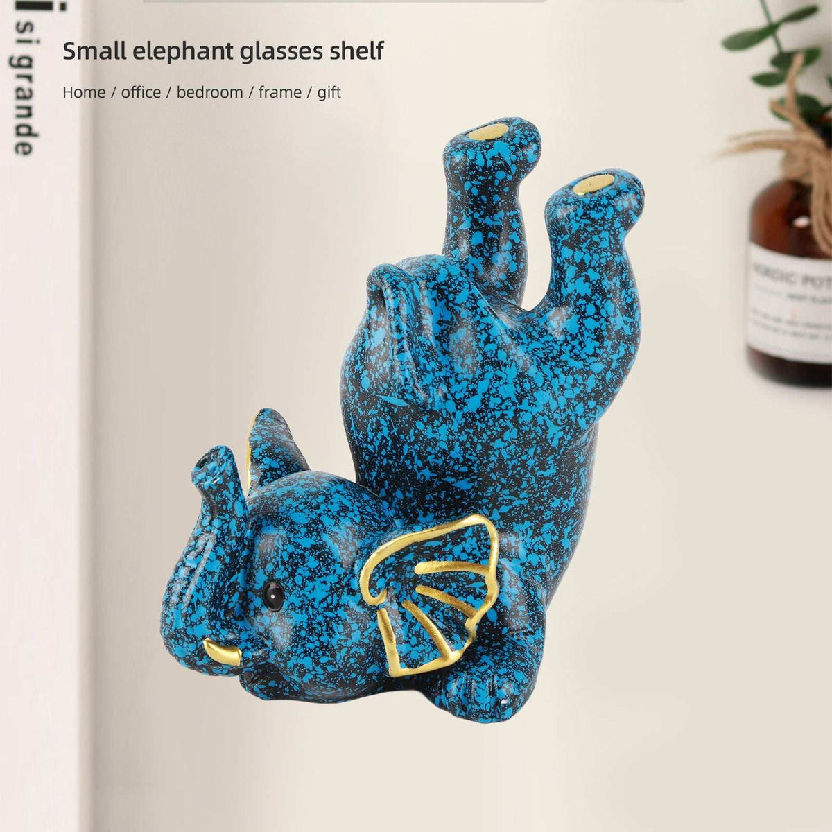 Creative Attraction Small Elephant glasses holder in mottled blue resin with gold accents and raised trunk for eyewear