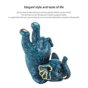 Creative Attraction Small Elephant glasses holder in dark blue resin with bright blue speckles and yellow accents, shaped as an elephant