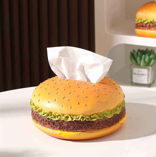 Creative Burger Tissue Box in orange plastic, shaped like a sesame-seed bun with lettuce and patty layers and tissues emerging