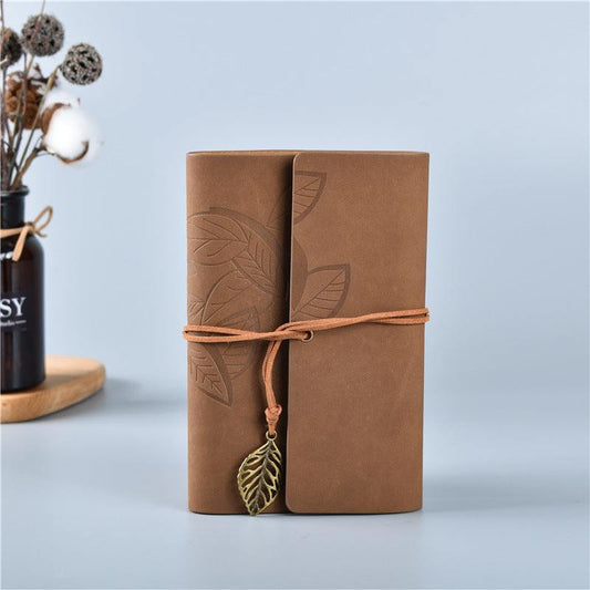 Dark Brown Vintage A5 journal with a warm brown embossed leaf-pattern cover, wraparound cord and dangling metal leaf charm