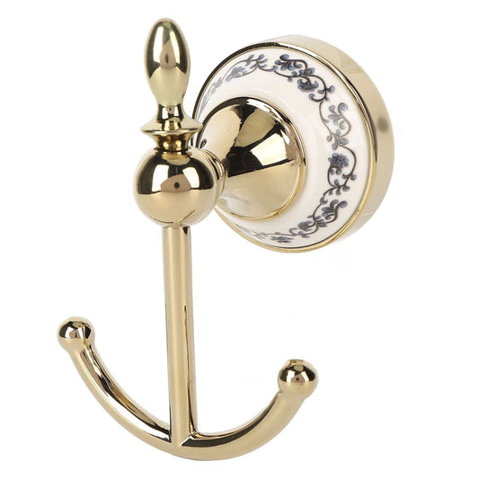 Decorative Wall Hook in polished gold-tone metal with a round white ceramic plate, blue floral scrollwork and double curved hooks