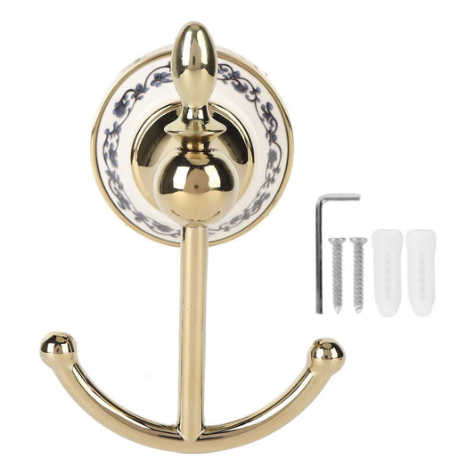 Decorative Wall Hook with polished gold-tone double arms and a round white ceramic backplate patterned with blue flowers