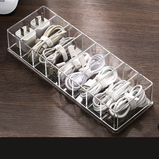 Desktop Data Cable Storage box in clear plastic with eight divided compartments filled with white charging cables and adapters