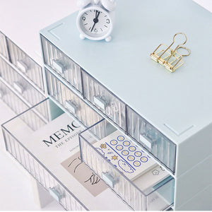 Desktop Drawer Organizer in pale blue plastic with clear striped fronts, featuring stacked drawers and two open compartments.
