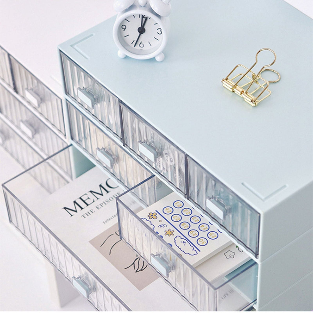 Desktop Drawer Organizer in pale blue plastic with clear striped fronts, featuring stacked drawers and two open compartments.