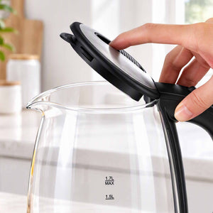 Devanti 1.7L Glass Electric Kettle with a clear glass body, black handle and raised stainless steel lid being opened