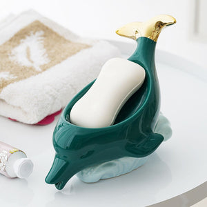 Dolphin Ceramic Soap Box in glossy teal with gold accents, sculpted dolphin shape holding a white bar of soap