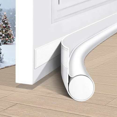 Door Draft Stopper in white flexible material, with a rounded tubular seal and adhesive strip attached beneath a door
