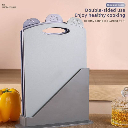 Double-Sided Antibacterial Kitchen Chopping Board Set with three light grey boards, food-icon tabs, and a matching storage stand
