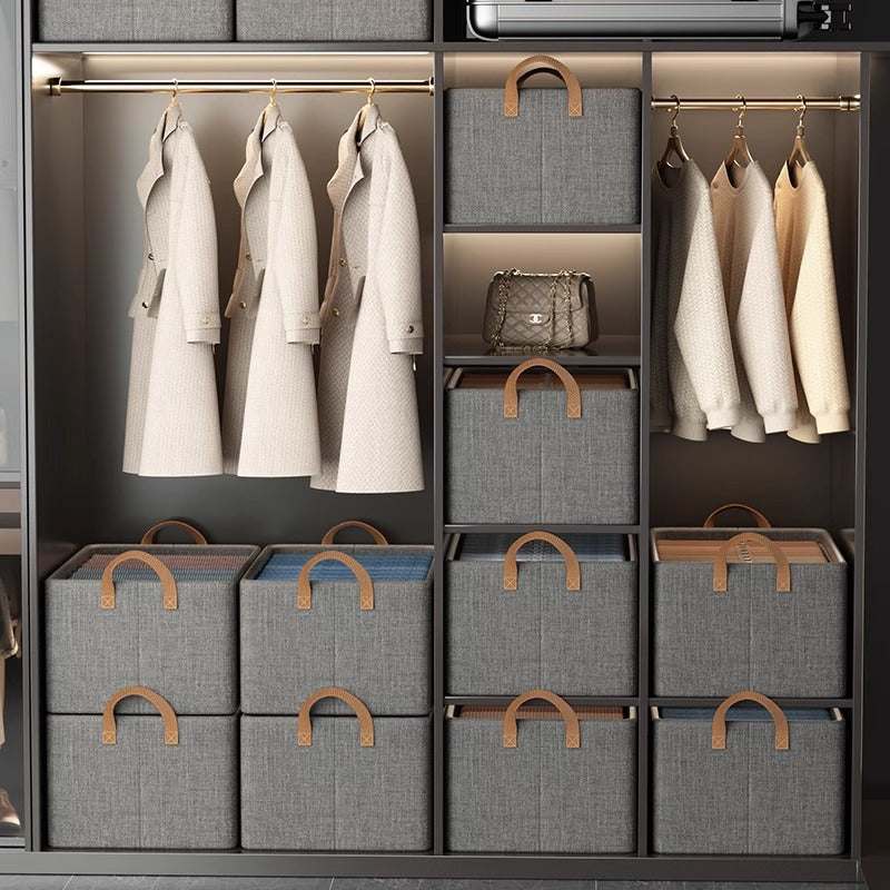 Foldable Fabric Storage Bin with grey woven fabric, brown leather-look handles and a structured rectangular shape