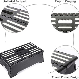 Folding Step Stool in black plastic with white anti-slip strips, a folding design, carry handle and rounded corners