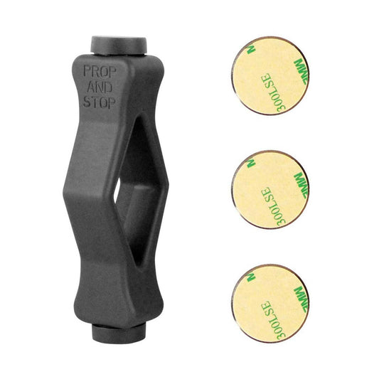 Front Load Washer Door Prop in dark grey molded material with an angular open center, alongside three round adhesive magnet stickers