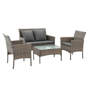 Gardeon 4-Piece Outdoor Sofa Set in grey woven rattan with dark cushions, two pillows and a glass-top coffee table