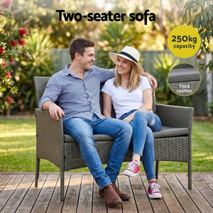 Gardeon 4-Piece Outdoor Sofa Set with a grey woven rattan two-seater sofa, thick dark cushions and metal legs