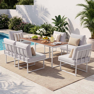 Gardeon 6 Seater Outdoor Dining set with white steel-framed sofas, pale cushions and two wood-look tables
