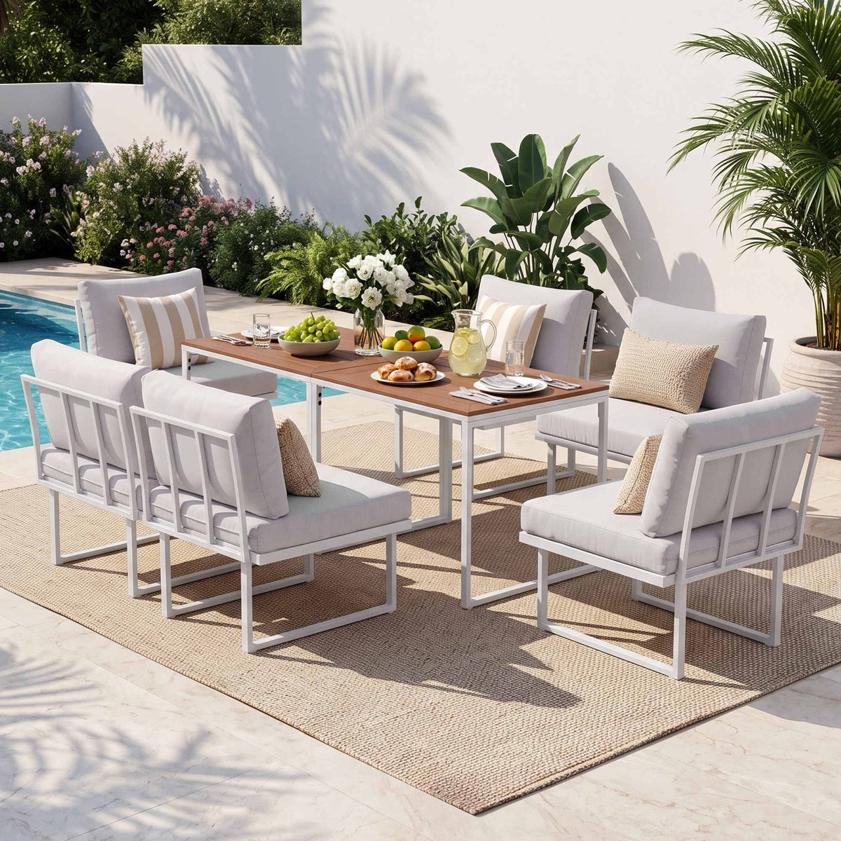 Gardeon 6 Seater Outdoor Dining set with white steel-framed sofas, pale cushions and two wood-look tables