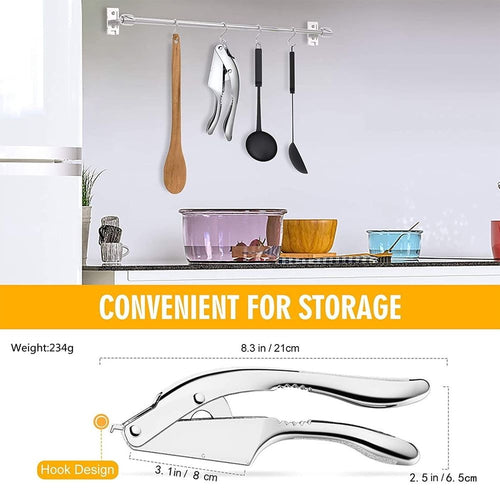 Garlic Press Garlic Press is a polished silver metal handheld garlic crusher with curved handles, perforated chamber and hanging hook