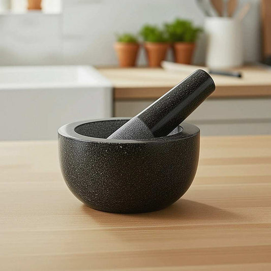 Granite Mortar & Pestle set in dark grey speckled stone, with a rounded bowl and matching angled pestle