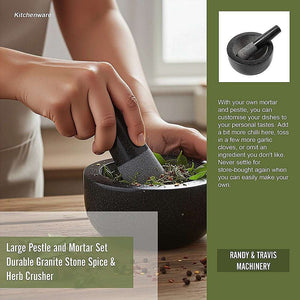 Granite Mortar & Pestle in dark grey speckled stone, with a deep bowl and matching pestle crushing herbs