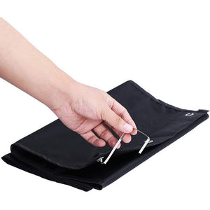 Hanging Wall Organiser in black Oxford cloth, folded flat with metal hanging eyelets and a clear fastening loop