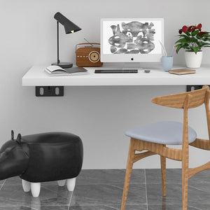 Heavy Duty Hidden Shelf Brackets support a white floating desk, with black wall-mounted metal brackets visible underneath
