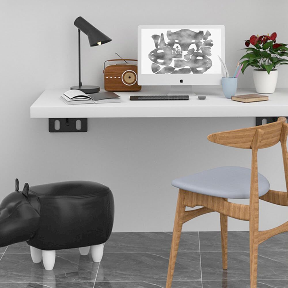 Heavy Duty Hidden Shelf Brackets support a white floating desk, with black wall-mounted metal brackets visible underneath