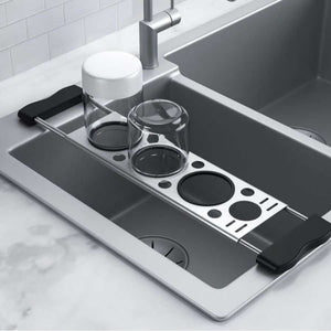 Heavy-Duty Stainless Steel Kitchen sink drying rack in silver metal with black end grips and circular drainage openings