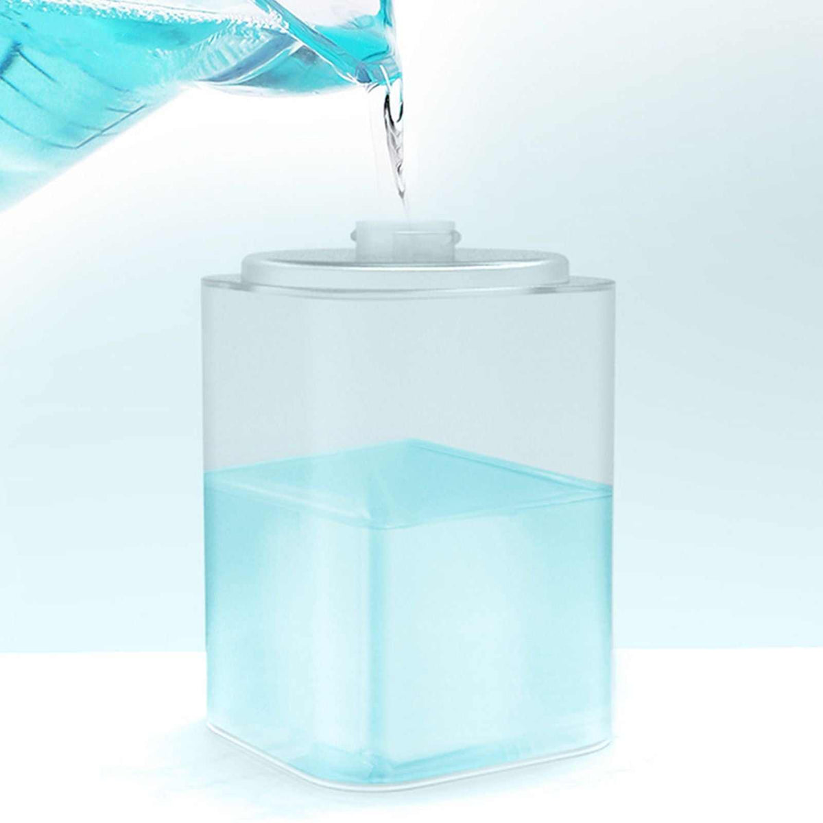 Infrared Automatic Sensor soap dispenser with a clear square refillable reservoir, shown being filled with blue liquid