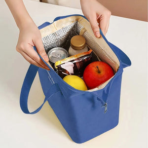 Insulated Lunch Bag in royal blue Oxford cloth with silver foil lining, long handles, front zipper pocket and open top.