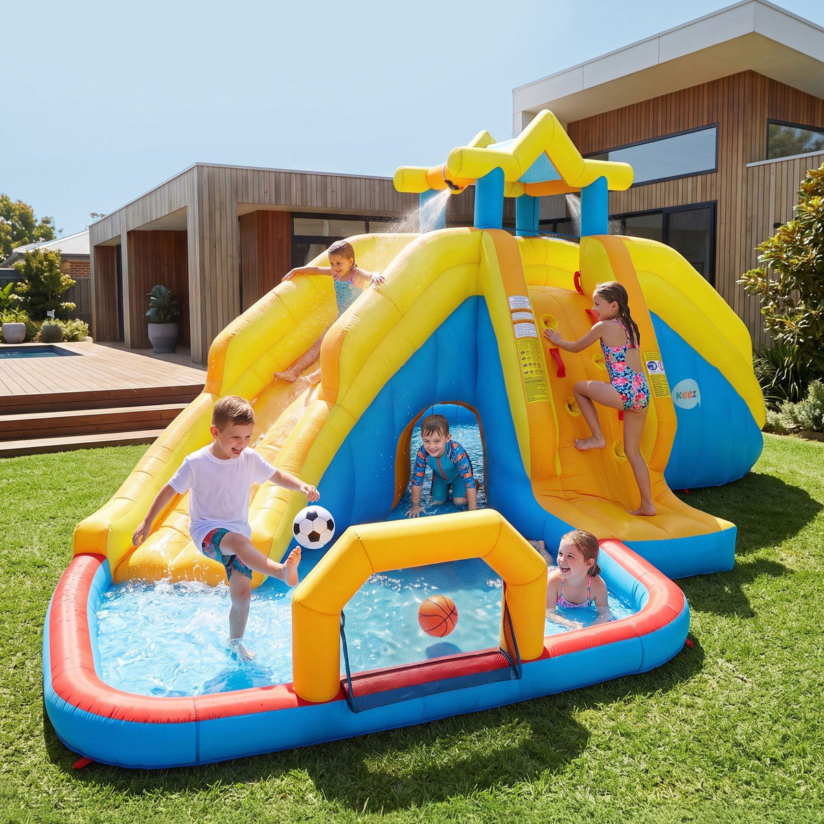 Keezi Inflatable Kids Pool in yellow and blue PVC, featuring curved slides, a splash pool, crawl tunnel and hoops