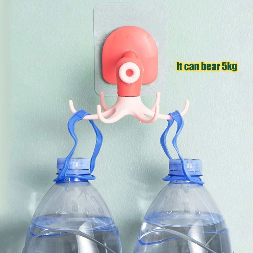 Kitchen 360° Rotated Hooks in coral pink and white plastic with curved prongs, holding two water bottles by their handles