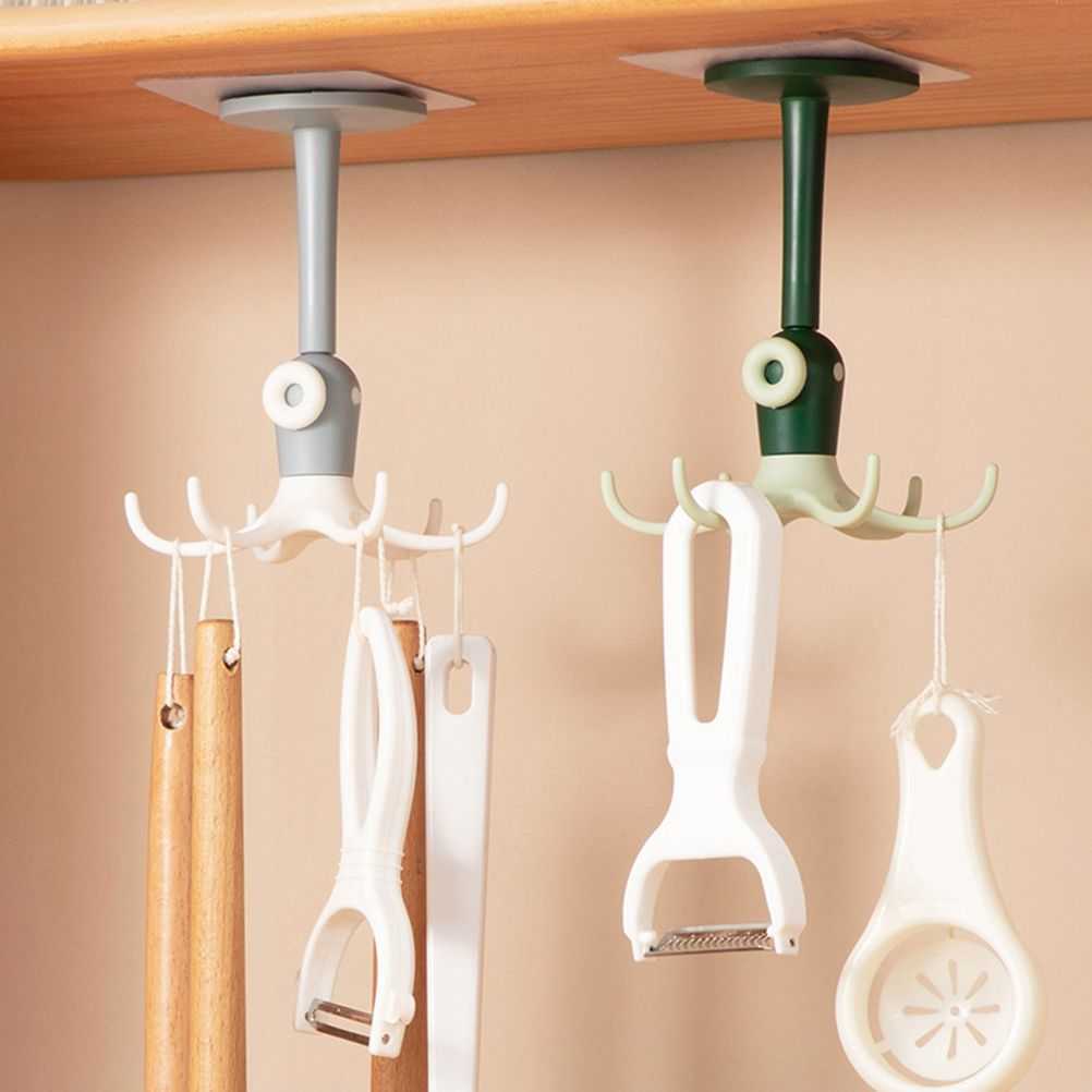 Kitchen 360° Rotated Hooks with white and green plastic rotating stems and multi-prong hooks holding kitchen utensils