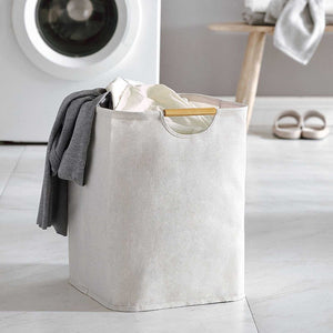 Laundry Basket Waterproof in light beige cotton linen with a soft textured finish and cutout handles, holding clothes
