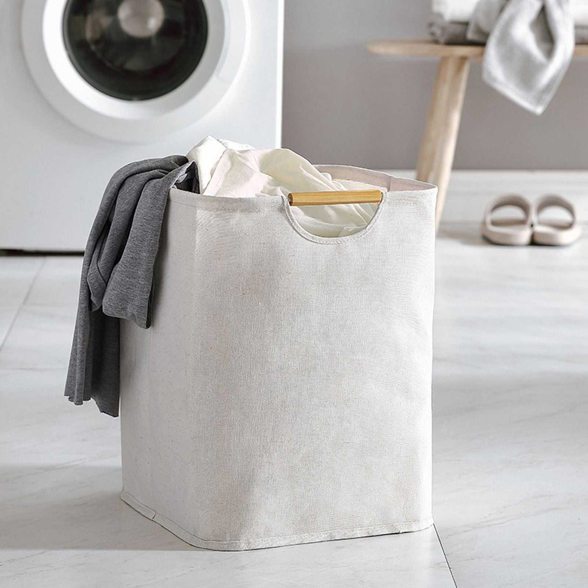 Laundry Basket Waterproof in light beige cotton linen with a soft textured finish and cutout handles, holding clothes