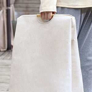 Laundry Basket Waterproof in cream cotton-linen fabric, with a flat collapsible shape and a wooden carry handle.