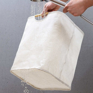 Laundry Basket Waterproof in off-white fabric, shown with water pouring through its soft, collapsible body