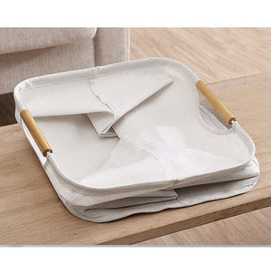 Laundry Basket Waterproof in off-white cotton-linen fabric, folded flat with wooden handles and a soft rectangular shape