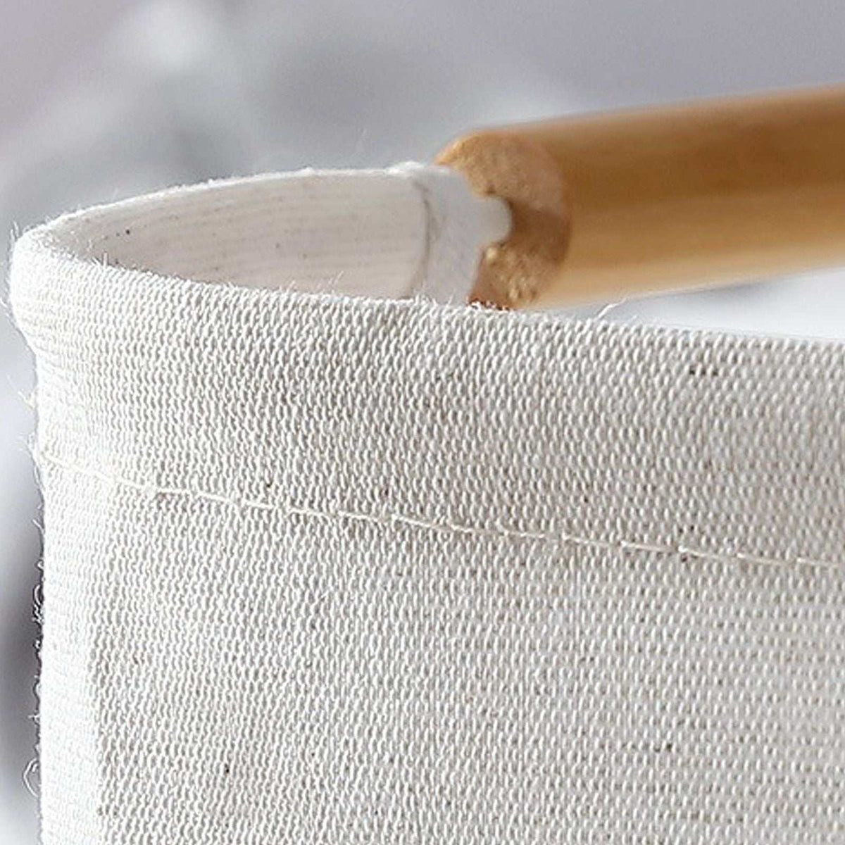Laundry Basket Waterproof hamper in white woven fabric, featuring a reinforced stitched rim and smooth wooden handle