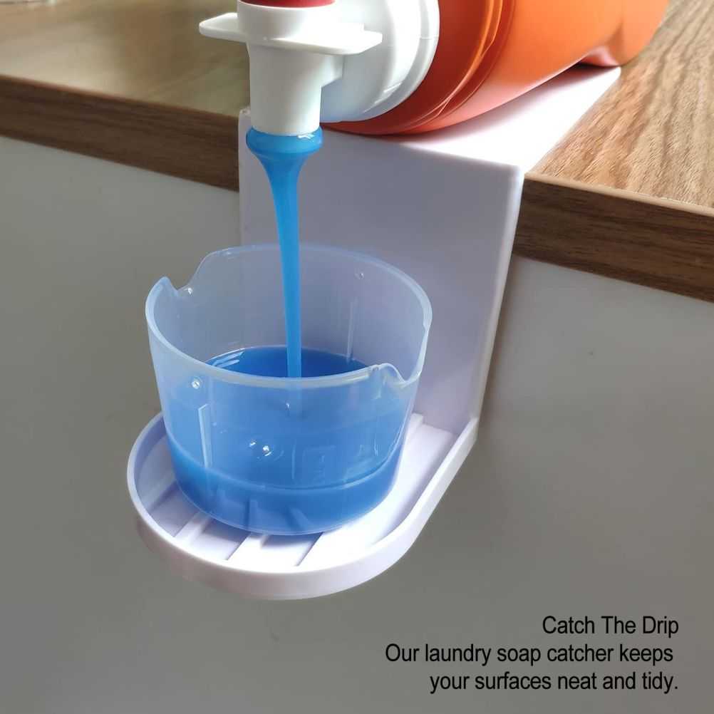 Laundry Detergent Holder in white plastic catches blue detergent flowing from an orange dispenser into a cup