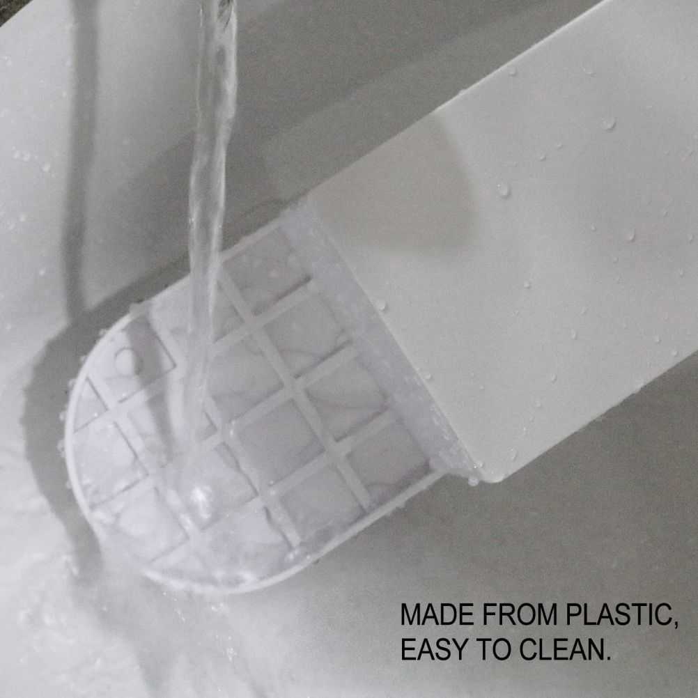 Laundry Detergent Holder in white plastic with a rounded grid base, shown rinsed under running water for easy cleaning