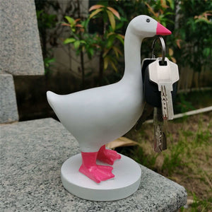 Magnetic Goose Key Holder in white resin with a pink beak and feet, holding a set of keys at its beak