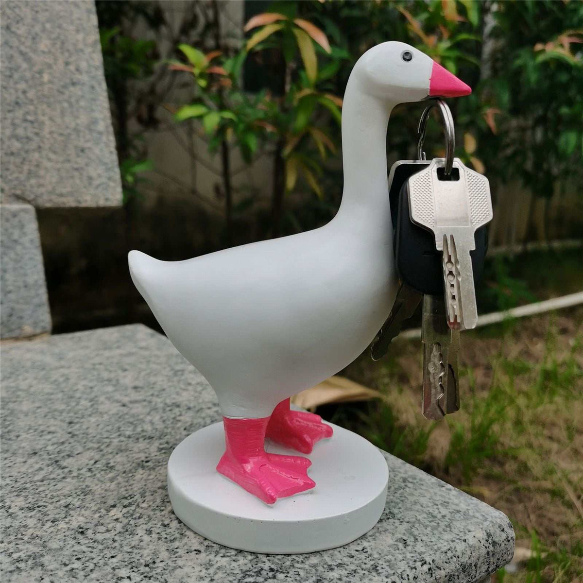 Magnetic Goose Key Holder in white resin with a pink beak and feet, holding a set of keys at its beak