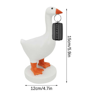 Magnetic Goose Key Holder in white resin with an orange beak and feet, holding a black key fob in its beak