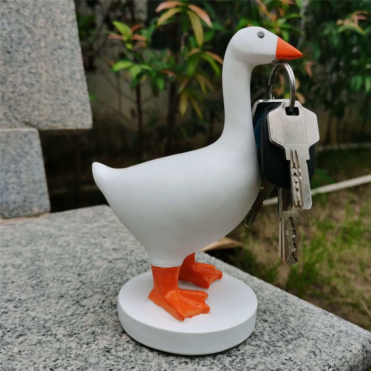 Magnetic Goose Key Holder made of white resin with an orange beak and feet, holding metal keys in its beak